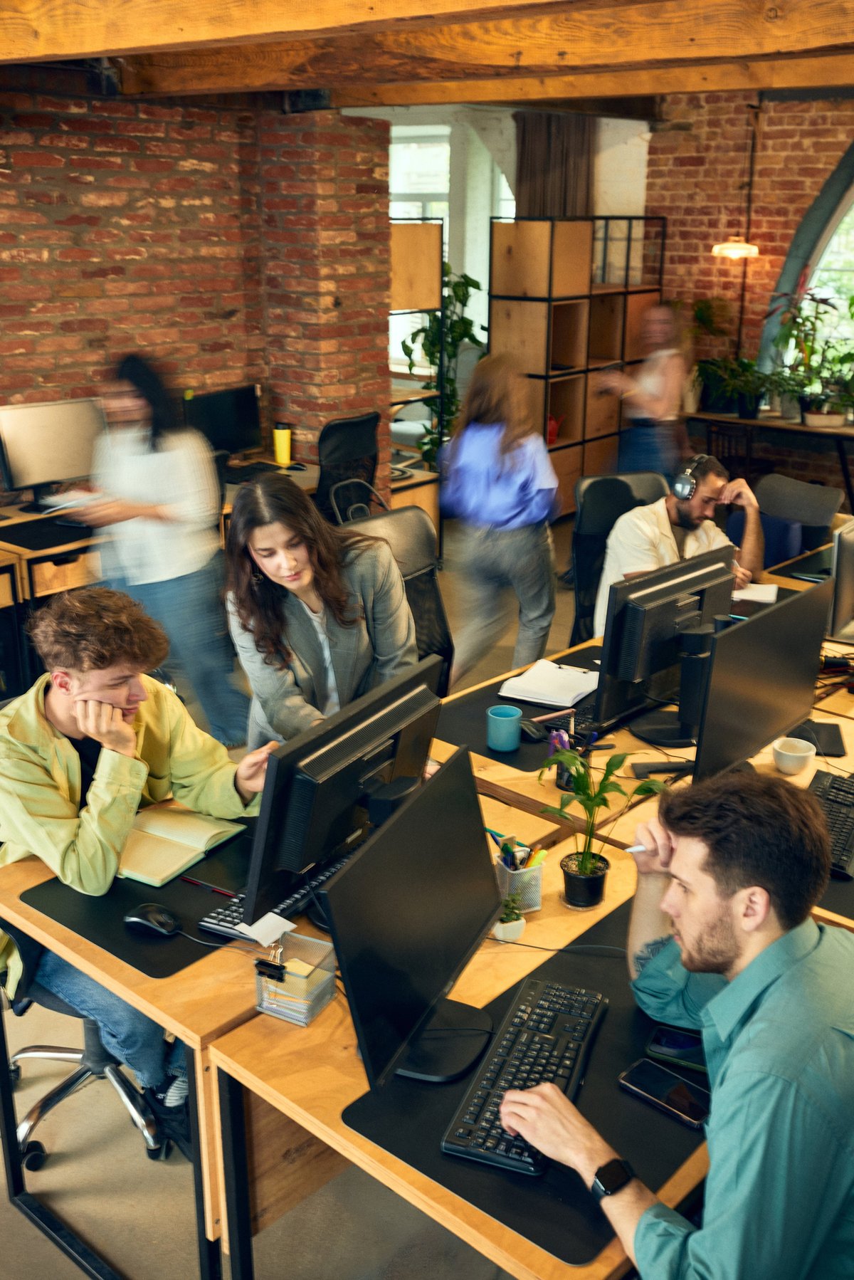 Creative team working together at computers in an office